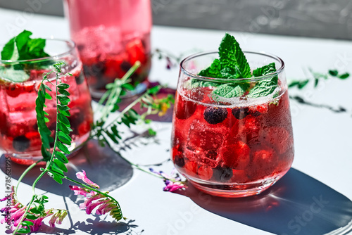 Berry refreshing cold summer drink. Cocktail or mocktail with ripe seasonal berries and mint. Detox drink. Fruit iced thirst quenching drink.