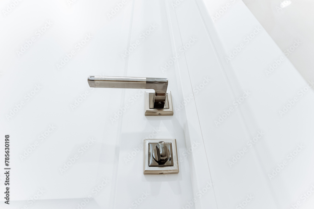 Grey handle on white bathroom door, locking mechanism, bottom view of ...