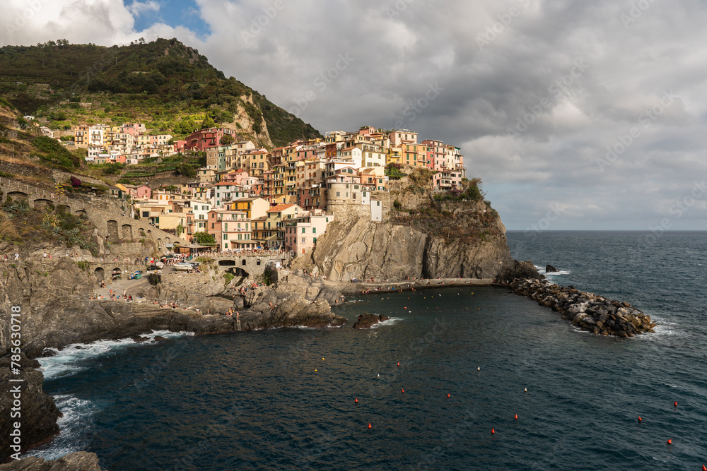 Manarola town on a cliff, and its bay at sunset
