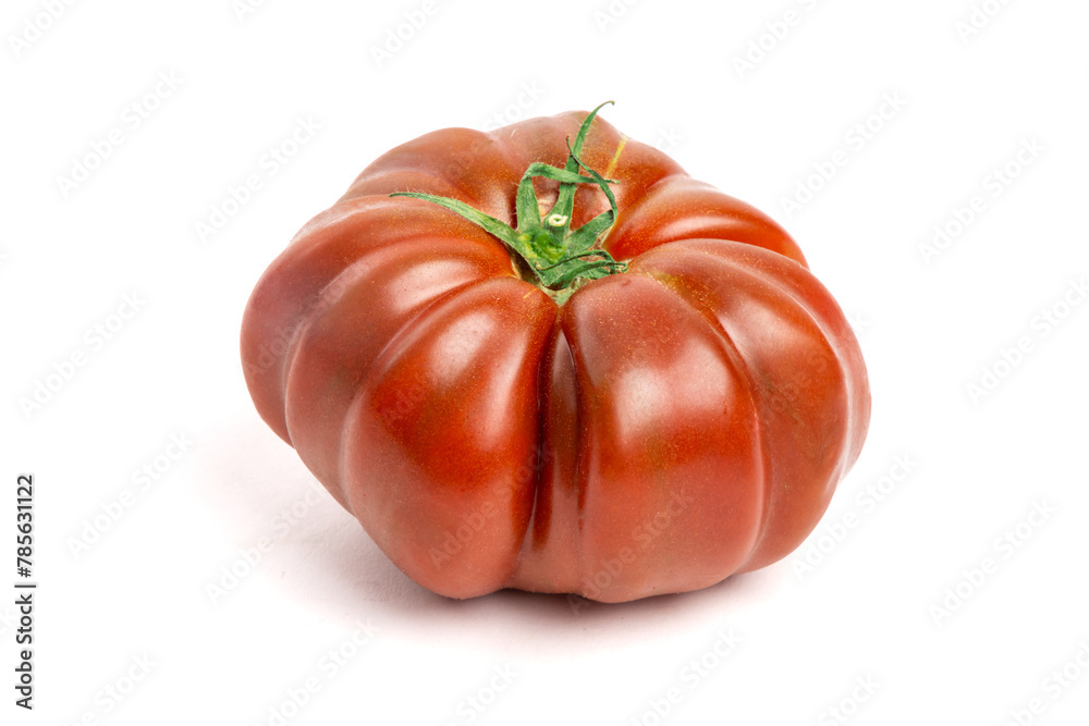 Multi colored red heirloom tomatoes with distinctive wrinkles and creases and irregular shape isolated on white Multi colored red heirloom tomatoes with distinctive wrinkles and creases and irregular shape isolated on white
