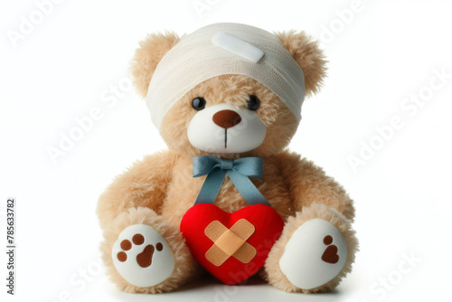 A sick teddy bear with a bandage on on a bright white background