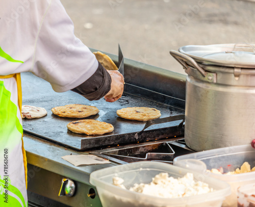 Persona cocinando pupusas una comida típica de El Salvador photo