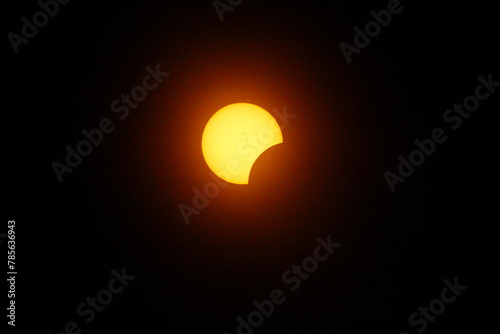 Fototapeta Naklejka Na Ścianę i Meble -  Partial Solar Eclipse, Between First and Second Contacts, Sun Seen with Solar Filter, April 8, 2024, Dublin, Ohio