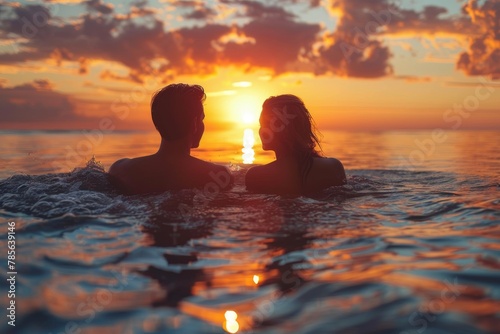 Intimate silhouette of a couple in the ocean facing a stunning sunset  epitomizing romance and connection