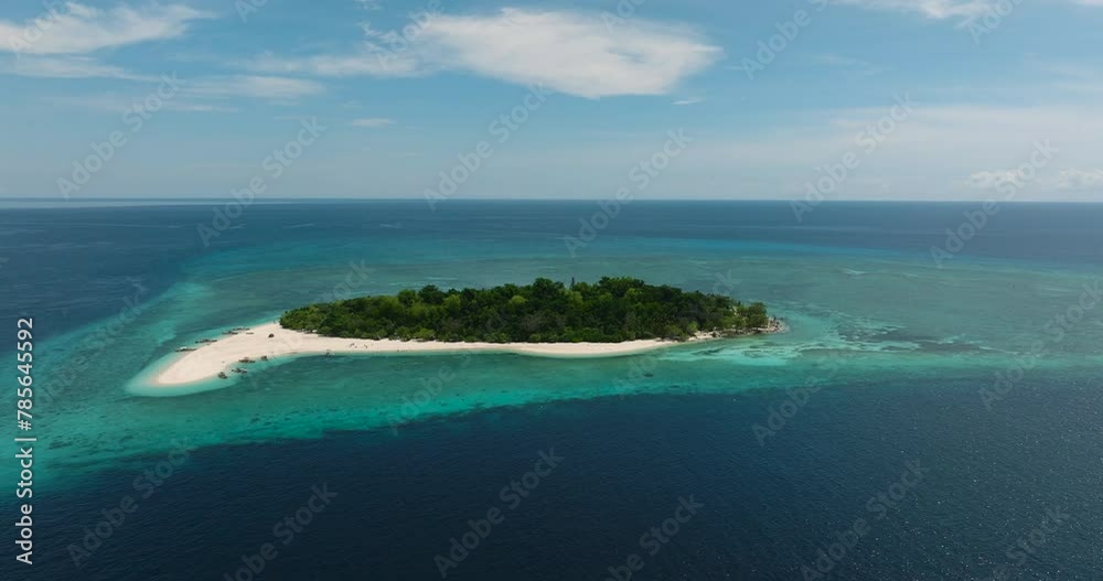 Mantigue Island surrounded by white beach and turquoise water. Blue sea, blue sky and clouds. Camiguin, Philippines. Mantigue Island surrounded by white beach and turquoise water. Blue sea, blue sky and clouds. Camiguin, Philippines.