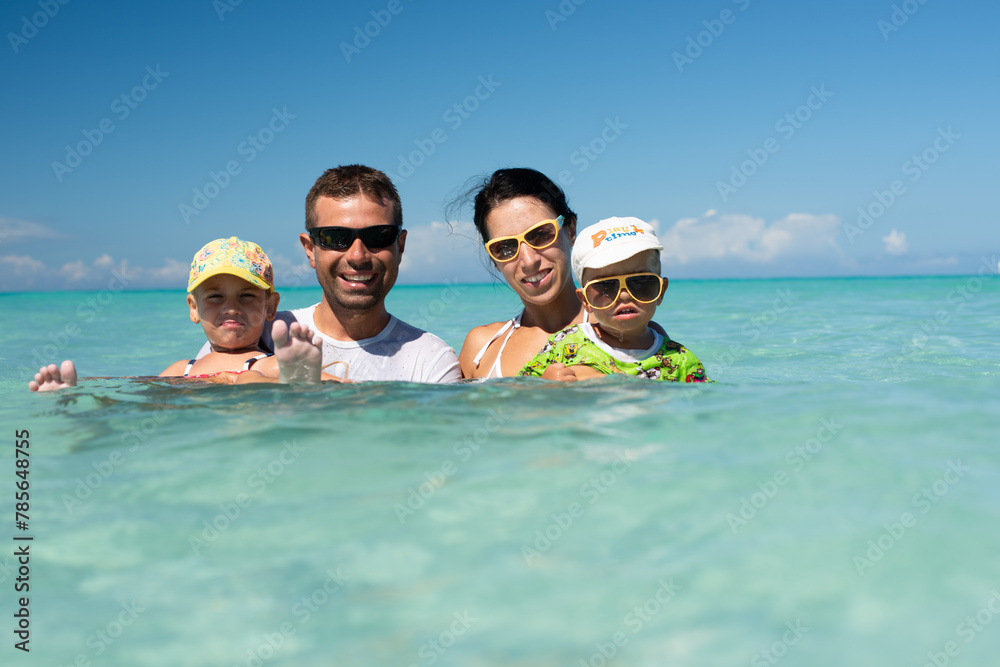 mom and dad with children, playing with kids, family on the beach ...
