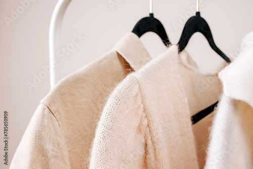 Close-up of Beige female clothing on the hangers