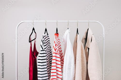 Wardrobe essentials, stylish woman's closing on the rack