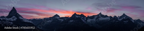 Majestic mountain peaks under a fiery sunset sky photo