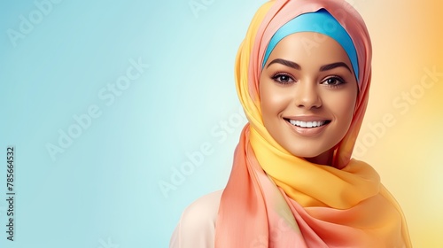 happy arabian girl in bright colourful scarf on pastel background