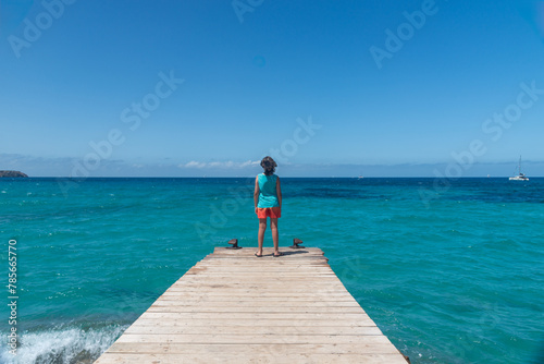 Boy looking at the sea in summer