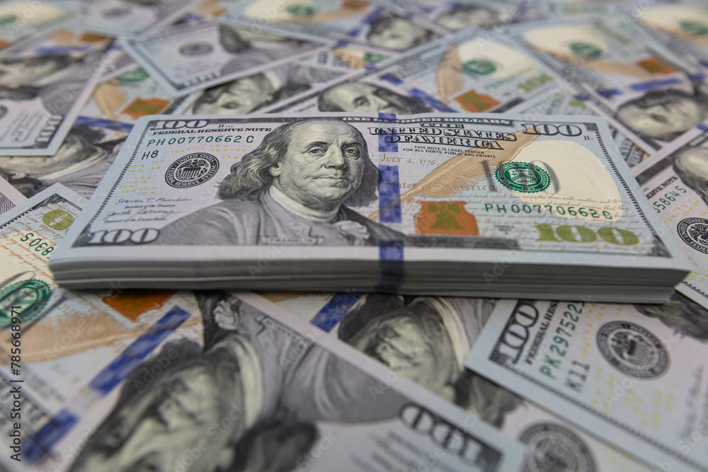 Pile of US 100 dollar banknotes on dollars background Pile of US 100 dollar banknotes on dollars background