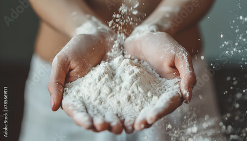 Flour in the woman's hands. Selective focus. Toned