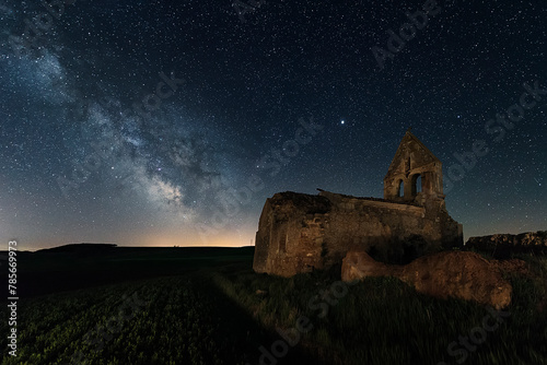 Ruins of the church of the abandoned town of San Jorde de Ojeda, near Herrera de Pisuerga, Palencia, under a starry sky in which the Milky Way stands out photo