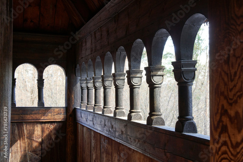 Norwegian wooden stave church exterior hallway with carved columns