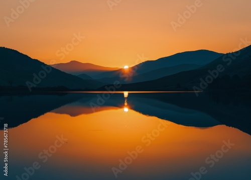 Sun Setting Over Lake With Mountains in Background