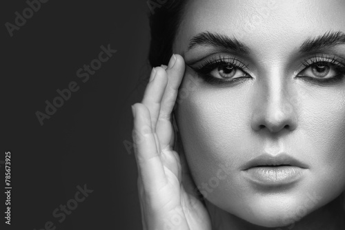 Portrait of woman with striking eye makeup and flawless skin