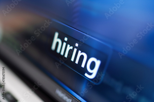 A close-up photo of the word "hiring" displayed on a computer screen,