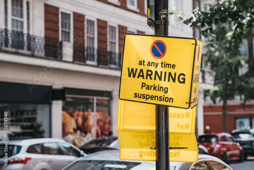 Yellow warning parking suspension sign on a residential street in Lodnon, UK. photo