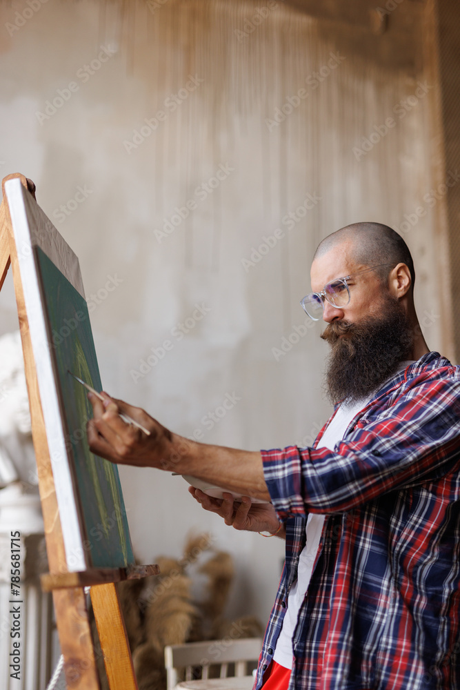 Moving paint brush artist works on abstract oil painting in creative modern studio. Abstract Modern Art. Vertical photo. Moving paint brush artist works on abstract oil painting in creative modern studio. Abstract Modern Art. Vertical photo.