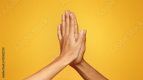 Man and woman greeting each other with high five photo