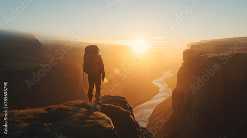 A lone backpacker standing at the edge of a majestic canyon at sunrise embodying the spirit of adventure and exploration.