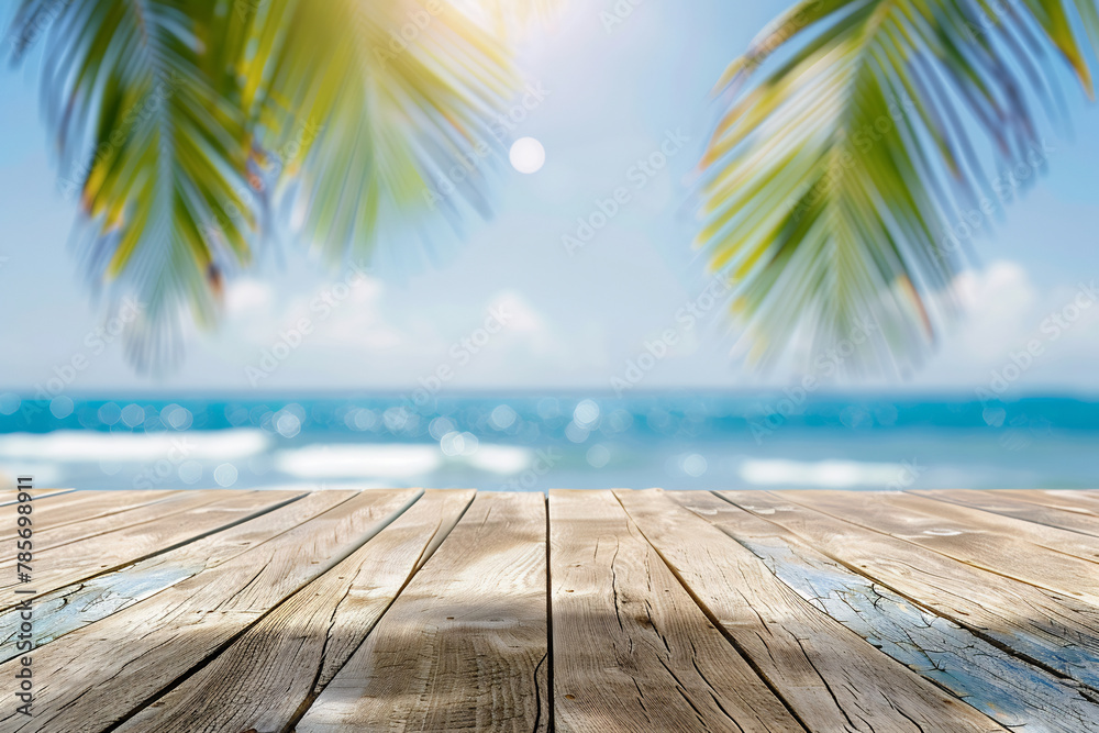 Empty wooden table top with blurred tropical beach background for product display montage Empty wooden table top with blurred tropical beach background for product display montage