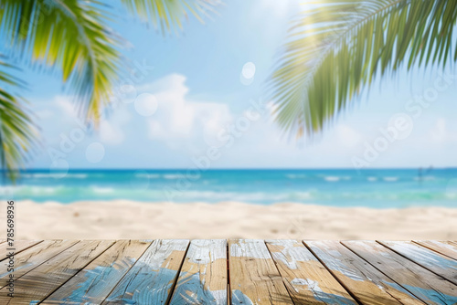 Empty wooden table top with blurred tropical beach background for product display montage © Miftakhul Khoiri