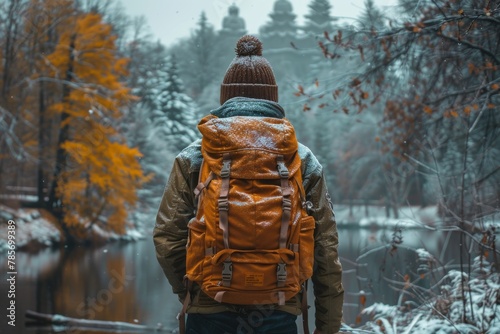 A solitary adventurer with a backpack contemplating a peaceful snowy forest by a lake, evoking a sense of wanderlust
