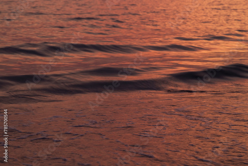 Ocean and small motion blurred waves at sunset. Natural tropical travel, vacation and summer background with copy space.