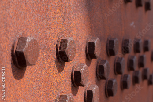 bolts screwed on steel plates photo