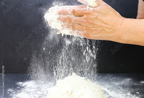 Woman's hands knead the dough for baking bread. The chef. Close-up of woman's hands kneading dough