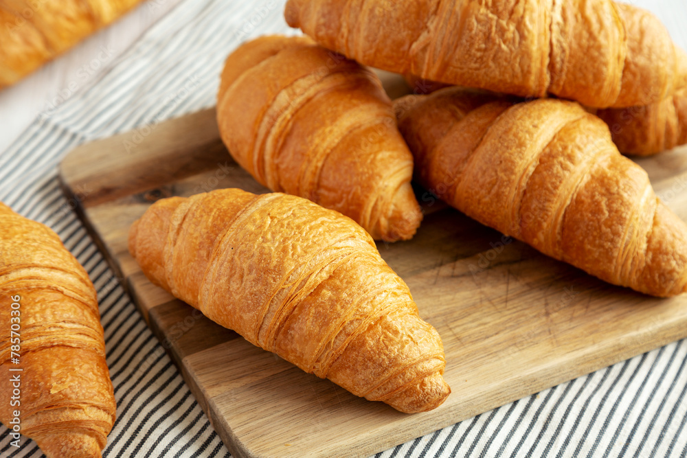 Homemade Breakfast Croissants on a Wooden Board, side view. Homemade Breakfast Croissants on a Wooden Board, side view.