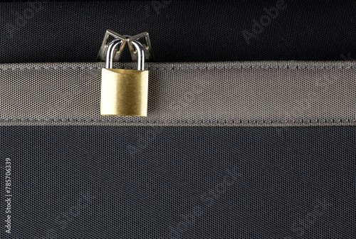 Small Brass Padlock on a Zippered Suitcase Pocket