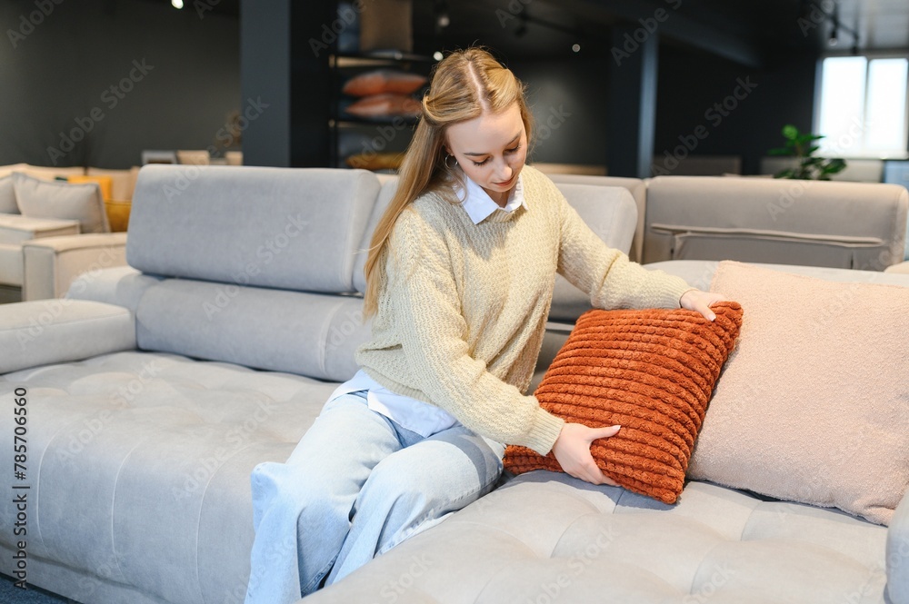 young woman shopping for furniture, sofa and home decor in store young woman shopping for furniture, sofa and home decor in store