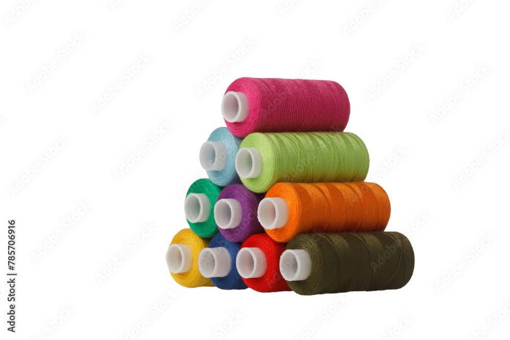 multi-colored spools of sewing thread in the form of a pyramid on a white background multi-colored spools of sewing thread in the form of a pyramid on a white background