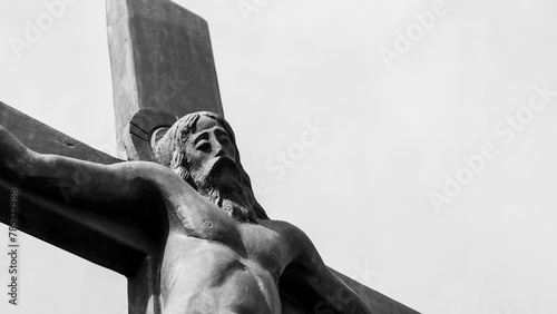 Crucifixion sculpture set against a sky background with copy space, close-up shot. © Topuria Design