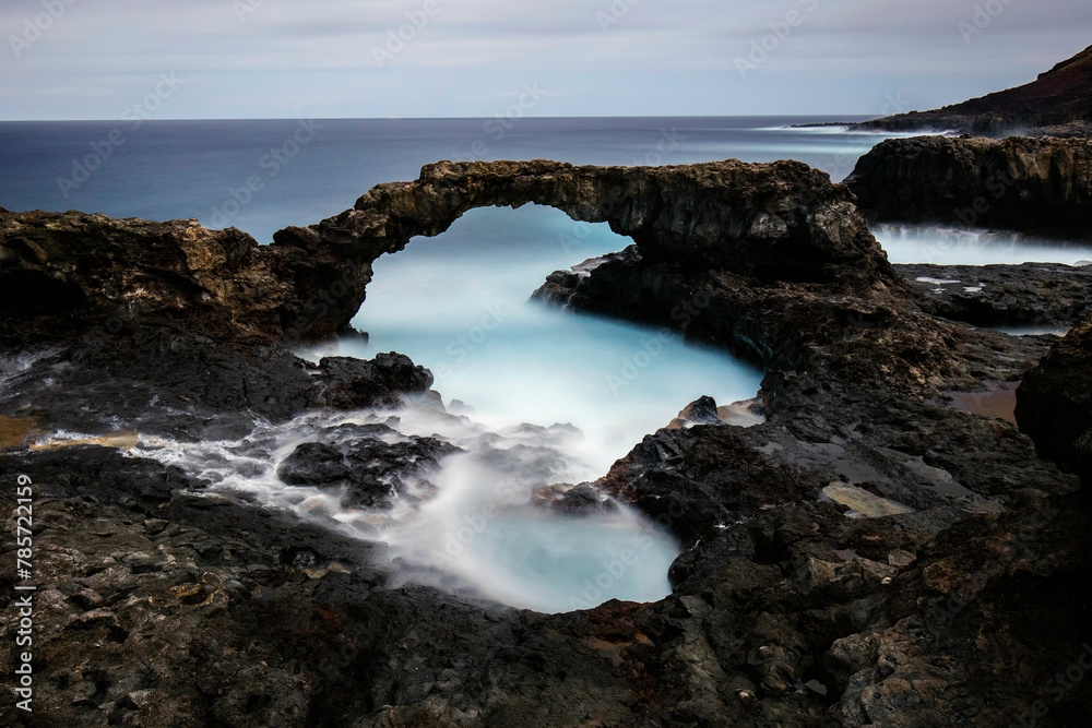 Majestic natural arch overlooking the ocean at dusk Majestic natural arch overlooking the ocean at dusk