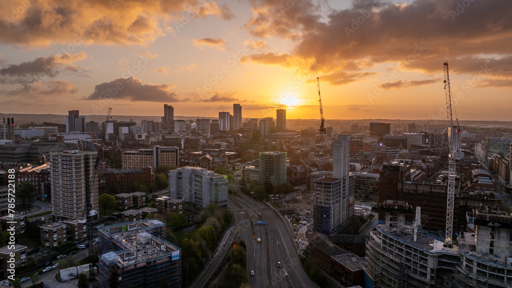 A drone captures the bustling Building and Construction activities in the heart of Leeds City Centre, set against the beginning of a new day at Sunrise