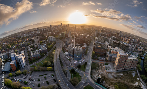 A breathtaking aerial view captures the essence of Leeds at sunrise, highlighting the city centre's buildings and the beauty of construction awakening in the light