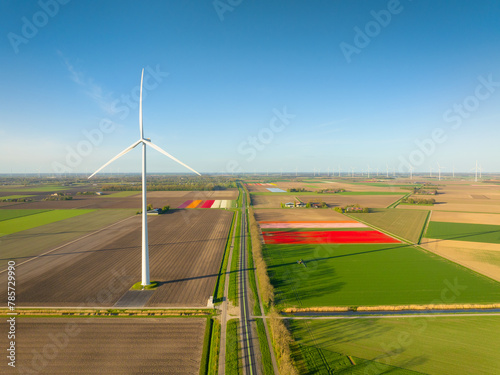 Fields and wind turbines. A wind generator on the  field. View from drone. Green energy production. Landscape from air at the day time. Photo for wallpaper and background.