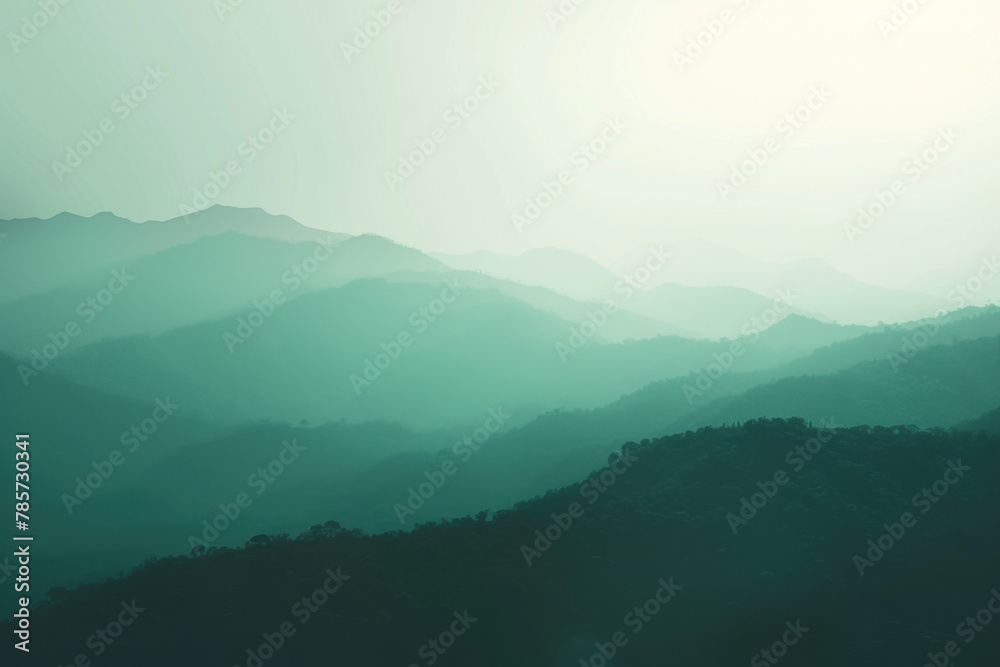 Layered Mountain Silhouettes with Mist Creating an Ethereal Green Landscape