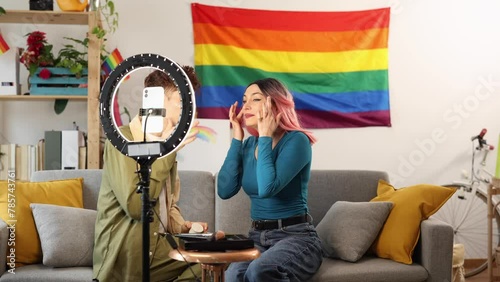 diverse happy friends record cosmetics and makeup tutorial in their living room - lgbt and gay pride concept
