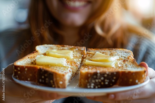 Macro shot of a woman relishing a slice of rich, buttery toast photo