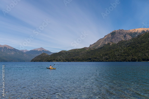 Young teenager practices kayaking and happily enjoys the landscape offered by Argentine Patagonia, Bariloche. © buenaventura13