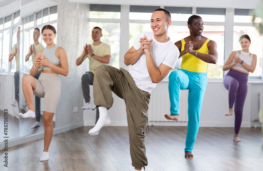 Fototapeta premium Happy young man and group of international dancers training before big performance in modern dance class