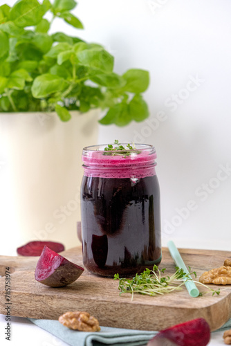 Beet smoothie. Beet smoothie with nuts and microgreens. Vertical 