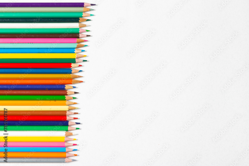 Set of colored pencils arranged in line on white background. Back to school. Set of colored pencils arranged in line on white background. Back to school.