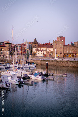 Calm evening, Gijón harbor, purple twilight, cityscape, serene sea, tranquil atmosphere.