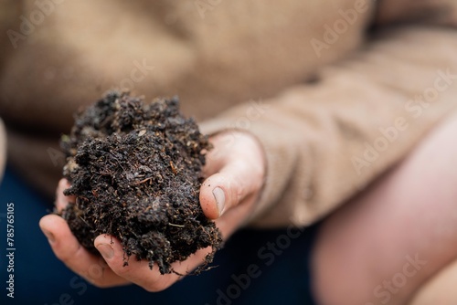 university student conducting research on forest health. farmer collecting soil samples in a test tube in a field. Agronomist checking soil carbon and plant health on a farm in australia